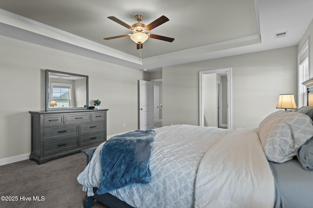 bedroom with carpet, a tray ceiling, ceiling fan, and crown molding