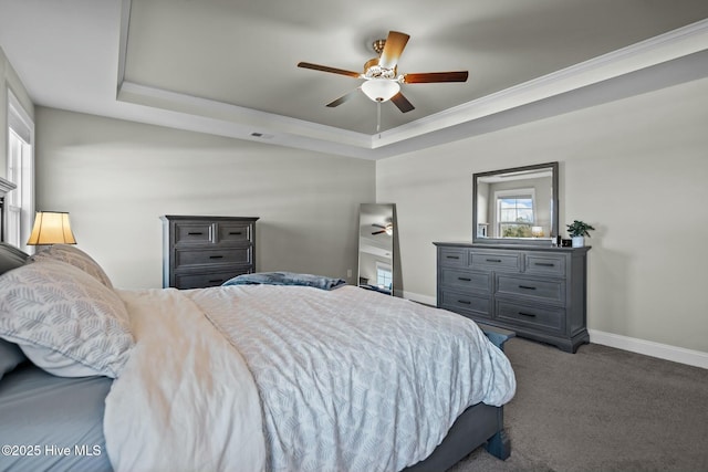 bedroom featuring carpet, a raised ceiling, ceiling fan, and ornamental molding