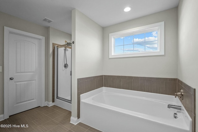 bathroom featuring separate shower and tub and tile patterned flooring