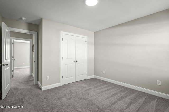 unfurnished bedroom with a closet and carpet floors