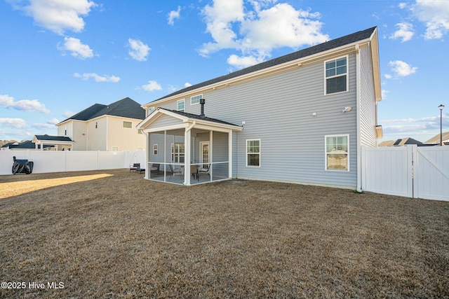 rear view of house featuring a lawn