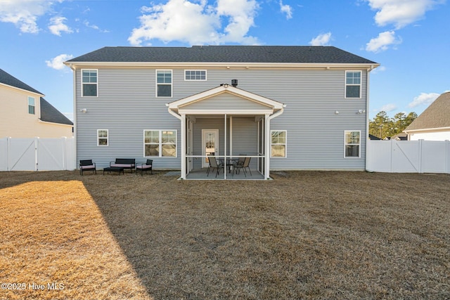 back of property featuring a lawn and a patio