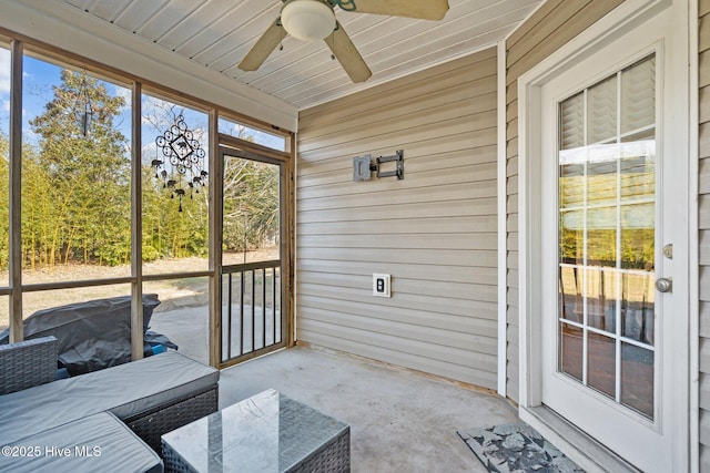 sunroom featuring ceiling fan