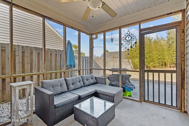 sunroom featuring a wealth of natural light, ceiling fan, and wooden ceiling