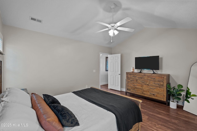 bedroom with ceiling fan, dark hardwood / wood-style floors, and vaulted ceiling