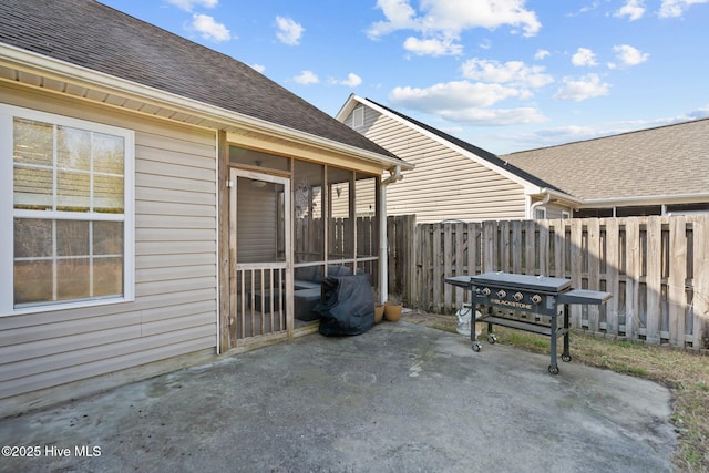 view of patio featuring area for grilling and a sunroom