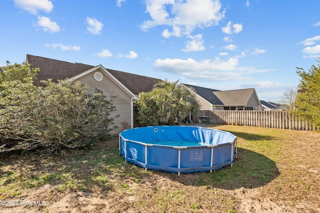 view of pool featuring a yard