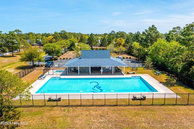 view of pool featuring a patio area, a sunroom, and a yard