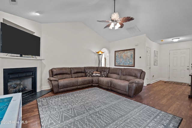 living room featuring dark hardwood / wood-style flooring, ceiling fan, and lofted ceiling