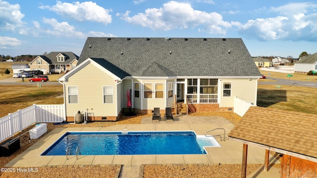 back of property featuring a fenced in pool and a patio