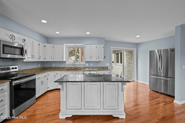 kitchen with white cabinets, a center island, and stainless steel appliances