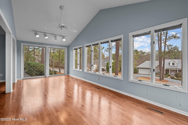 unfurnished sunroom featuring ceiling fan and vaulted ceiling