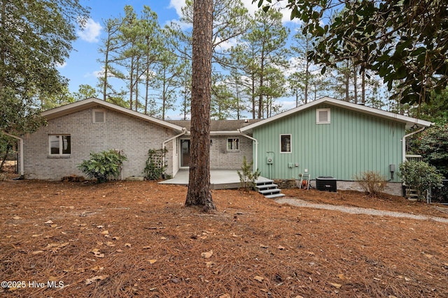 rear view of property with a patio area and central air condition unit