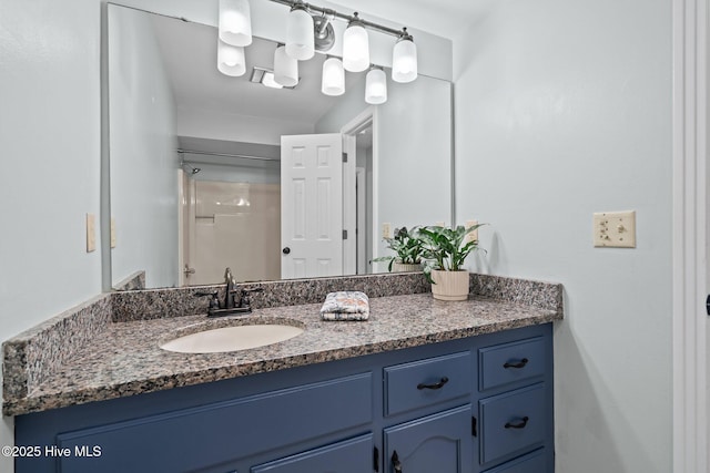 bathroom featuring a shower and vanity