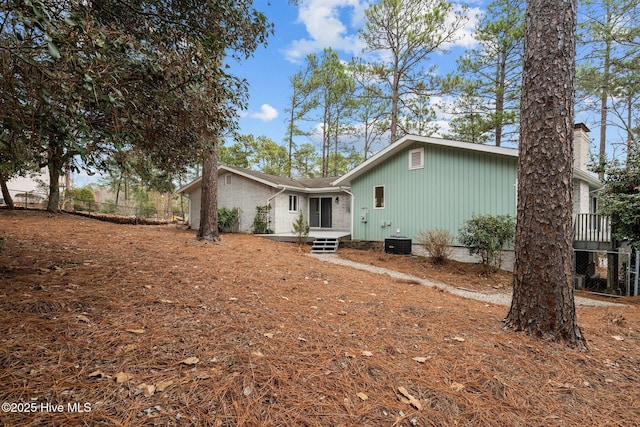 back of house featuring cooling unit