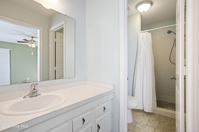 bathroom with toilet, vanity, ceiling fan, a textured ceiling, and a shower with shower curtain