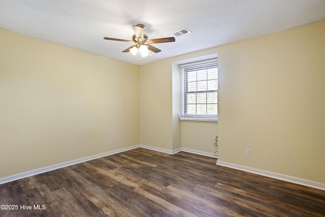 spare room with ceiling fan, dark hardwood / wood-style flooring, and a textured ceiling