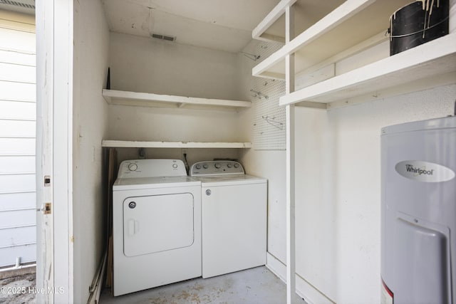 clothes washing area with water heater and washing machine and clothes dryer