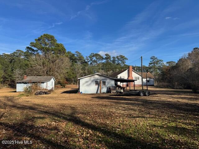 exterior space featuring a carport and a storage shed