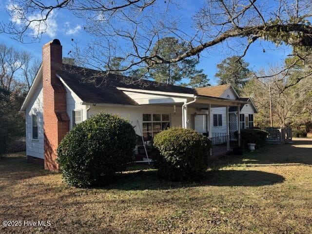 view of side of home featuring a yard