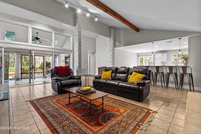 living room featuring beamed ceiling, ceiling fan, light tile patterned floors, and high vaulted ceiling