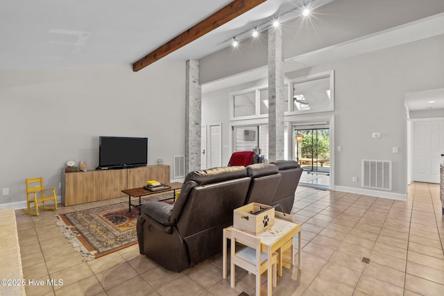 living room featuring light tile patterned floors, rail lighting, and beam ceiling