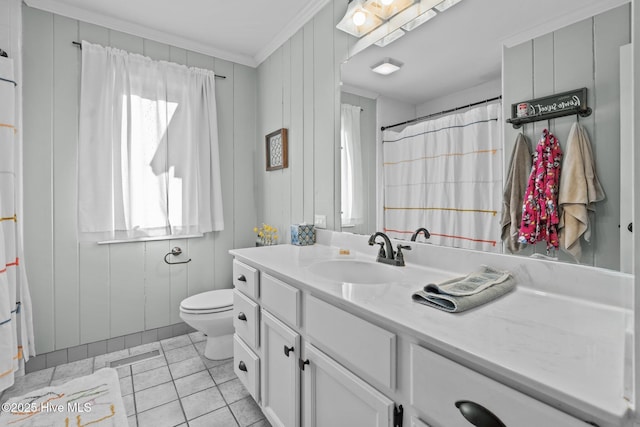 bathroom featuring tile patterned floors, ornamental molding, vanity, toilet, and wood walls