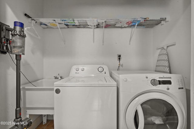 laundry area with tile patterned floors and washer and dryer