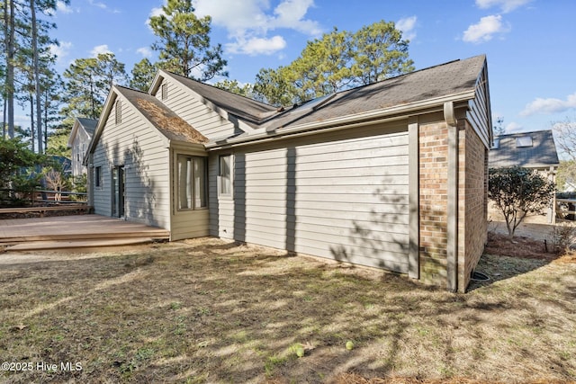 view of property exterior with a deck