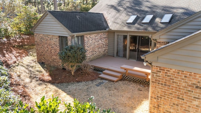 back of property with a wooden deck