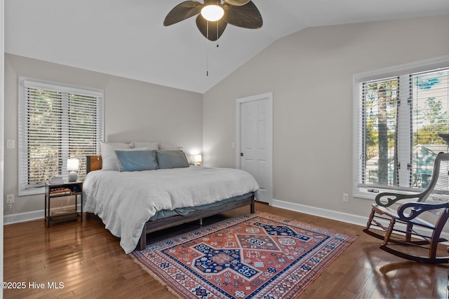 bedroom featuring multiple windows, ceiling fan, dark wood-type flooring, and lofted ceiling