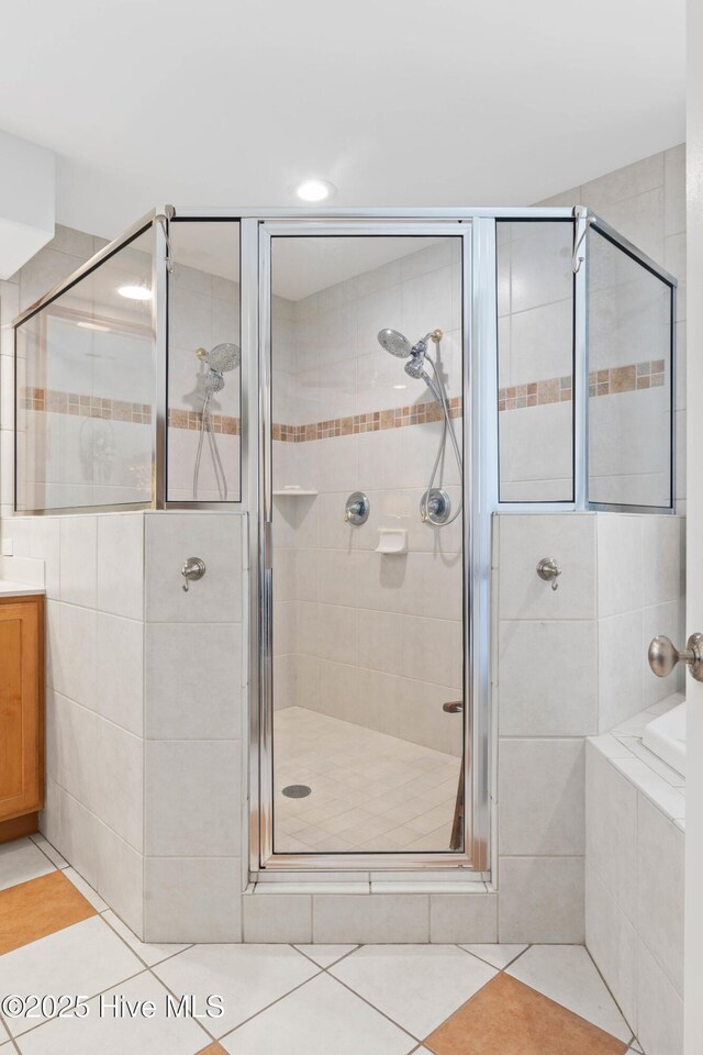 bathroom with independent shower and bath, vanity, and tile patterned floors