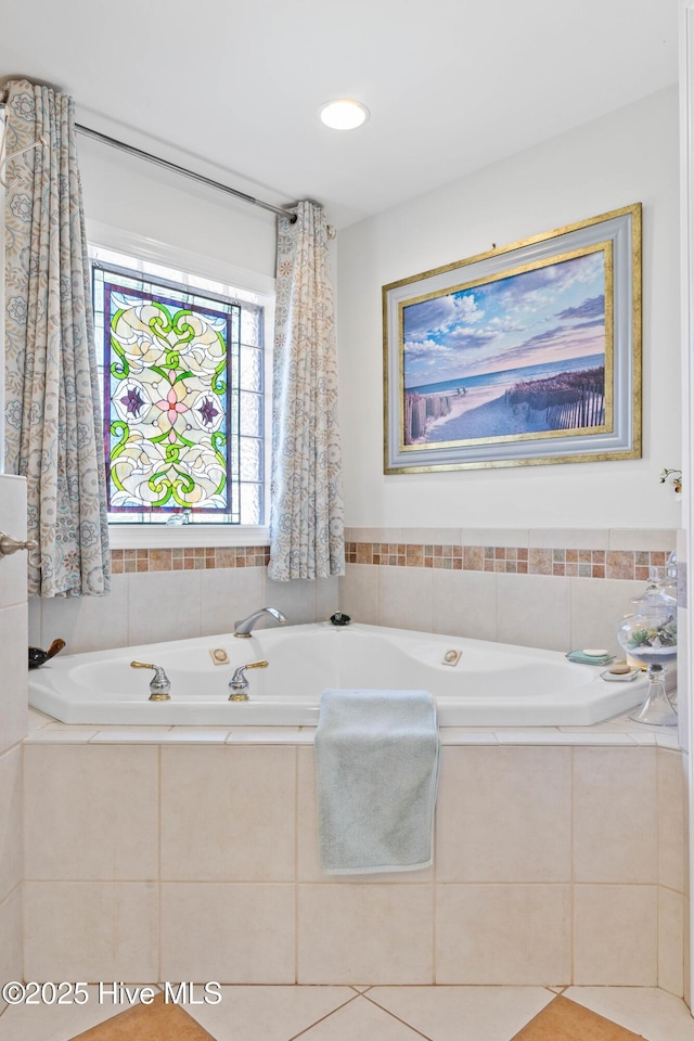 bathroom with a relaxing tiled tub