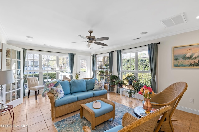 living room featuring crown molding, light tile patterned floors, and ceiling fan