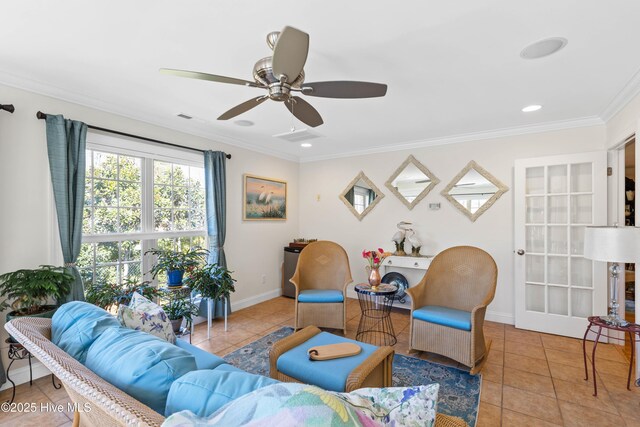 living room featuring crown molding, ceiling fan, and light tile patterned floors