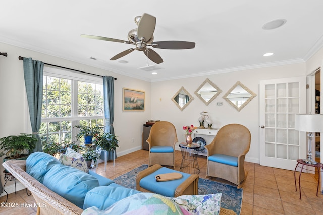 living room featuring tile patterned flooring, visible vents, baseboards, and crown molding