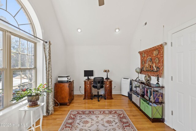 office with lofted ceiling and light wood-type flooring