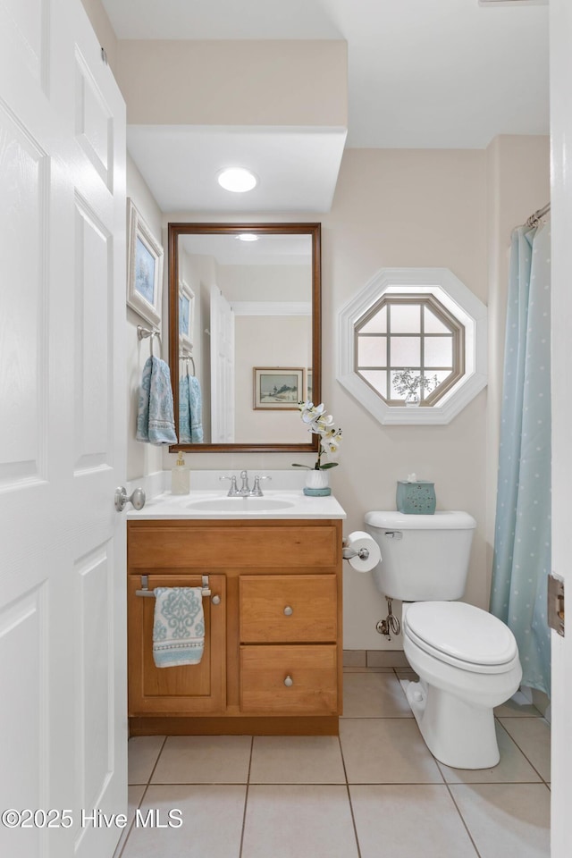 bathroom with vanity, tile patterned floors, and toilet