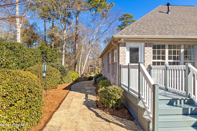 view of home's exterior featuring roof with shingles