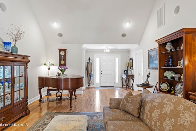 entryway featuring high vaulted ceiling, visible vents, baseboards, and wood finished floors