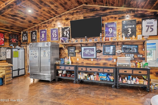 bar featuring lofted ceiling, wood walls, wood ceiling, and stainless steel refrigerator