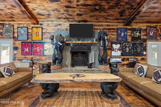 living room featuring wooden walls, a stone fireplace, and wooden ceiling