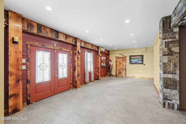 entryway with french doors and wooden walls