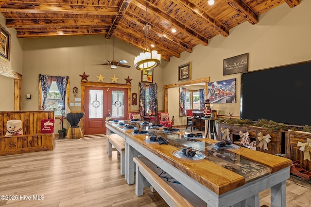 kitchen with beam ceiling, ceiling fan, french doors, high vaulted ceiling, and light hardwood / wood-style floors