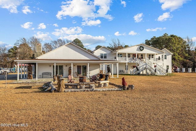 rear view of property featuring a porch and a carport