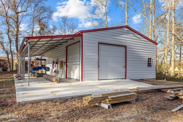 view of outbuilding featuring a garage and a carport