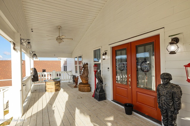 entrance to property featuring ceiling fan, french doors, and covered porch