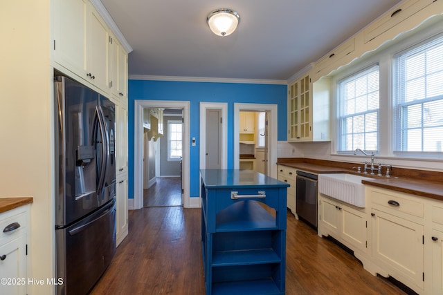 kitchen featuring a sink, refrigerator with ice dispenser, wooden counters, stainless steel dishwasher, and open shelves