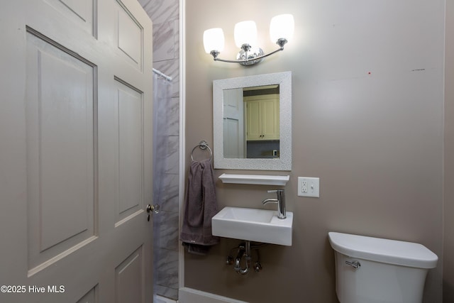 bathroom featuring a sink, toilet, and a shower with curtain