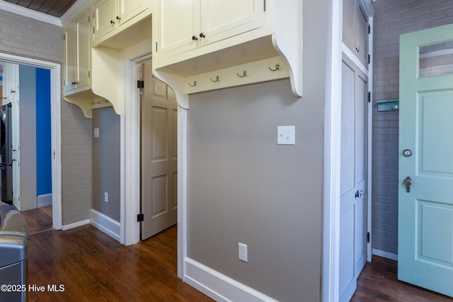 kitchen featuring freestanding refrigerator, dark wood-type flooring, white cabinetry, and baseboards